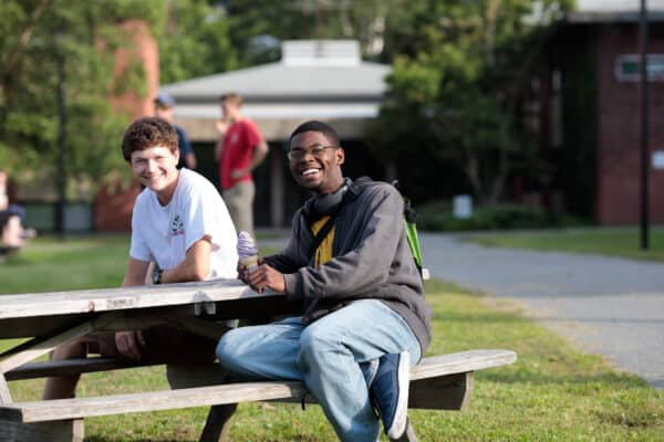Two male students enjoy ice cream during welcome weekend on the Randolph Center campus