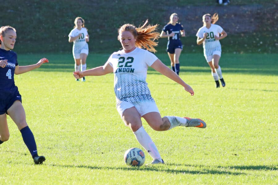 Woman soccer player readies to strike the ball on the Lyndon field.