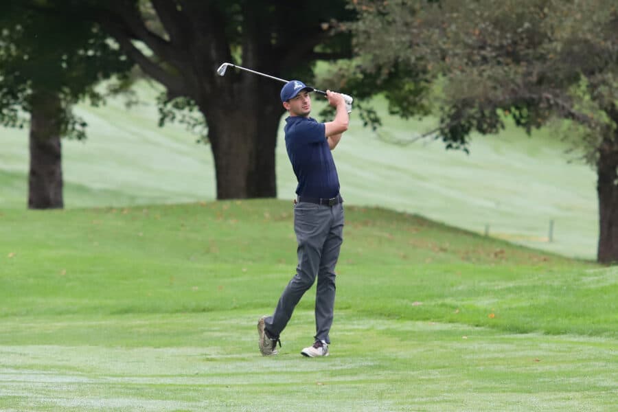 Male golf player watches his ball after a swing