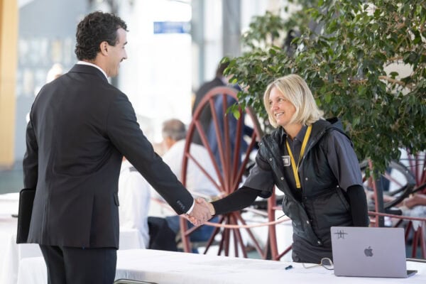A male student shaking hands with a female pilot during a mock interview