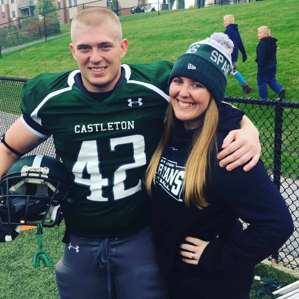 A photo of Ashley Billings, a young woman with long blonde hair smiling beside a young man with short blonde hair wearing a football uniform