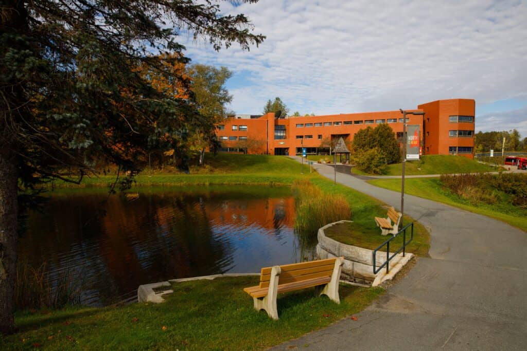 Aerial view of Lyndon campus. a pond in the foreground and brick buildings in the background.