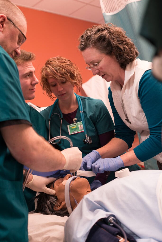 Respiratory Therapy students work on a manikin during lab