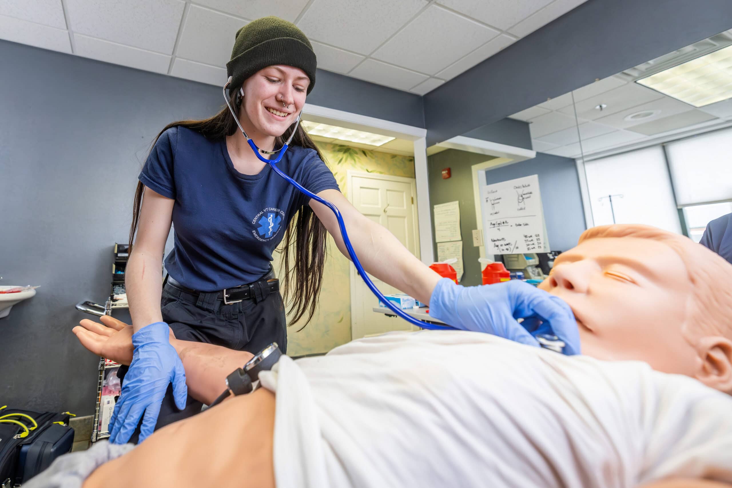 A student trains using a medical mannequin.