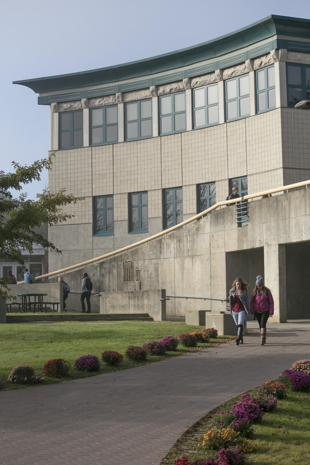 Students walk a paved path on the Vermont State University Lyndon campus.