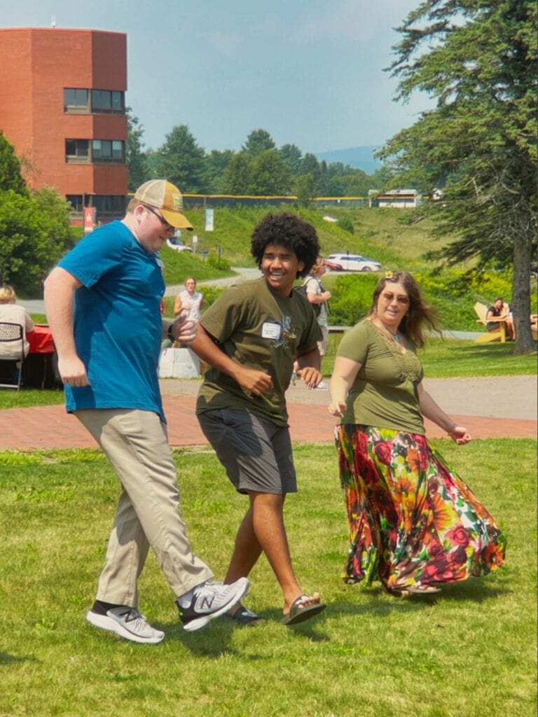 Three people line dancing outside at Vermont State University Lyndon.