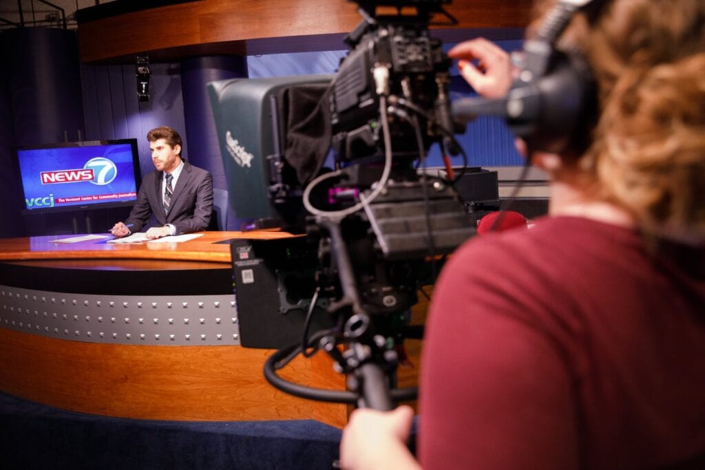 Journalist students record a broadcast in the news studio at Vermont State University Lyndon.