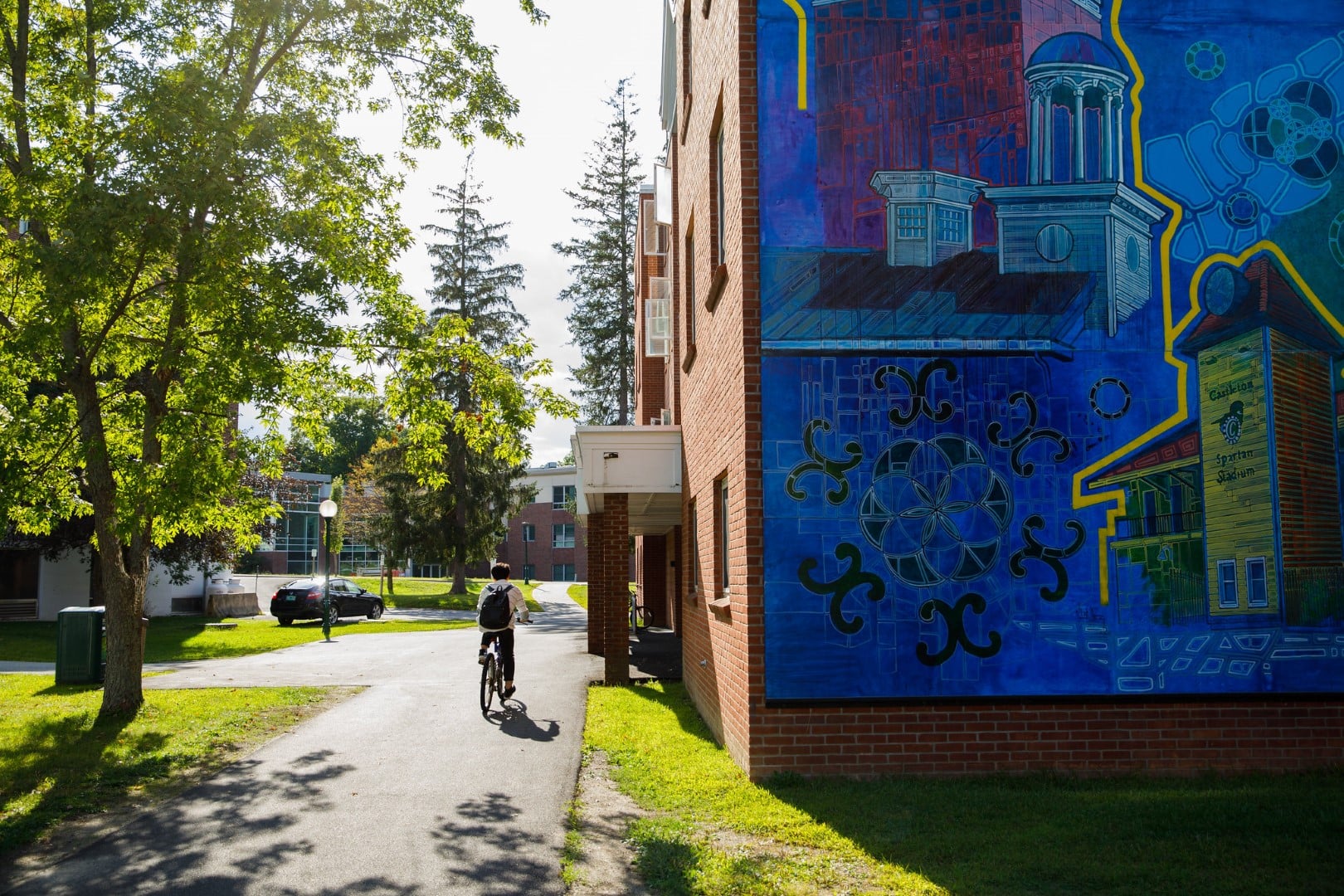 A mural on the side of a large brick building on the Vermont State University Castleton campus.