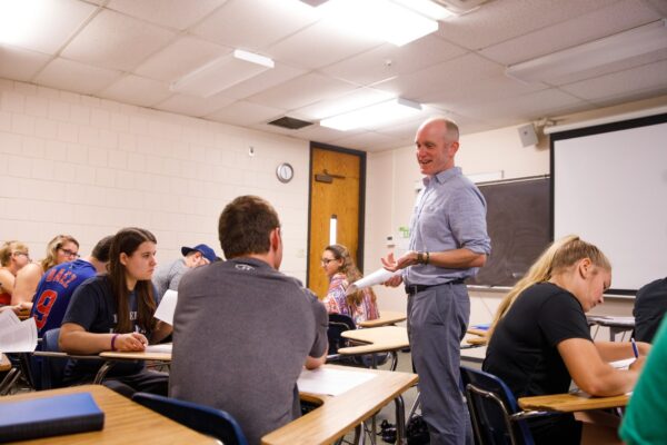 A man is talking to a class on the Vermont State University Castleton campus.