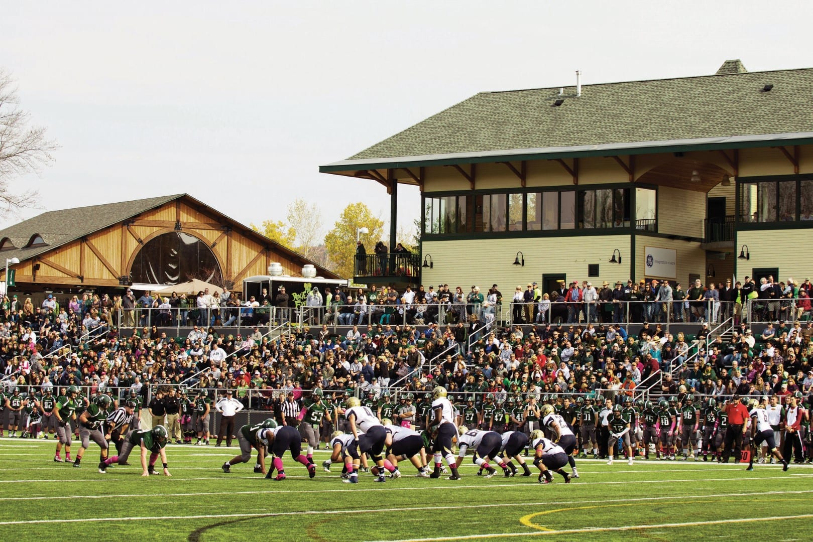 A full stadium cheering a football team on the Vermont State University Castleton campus.