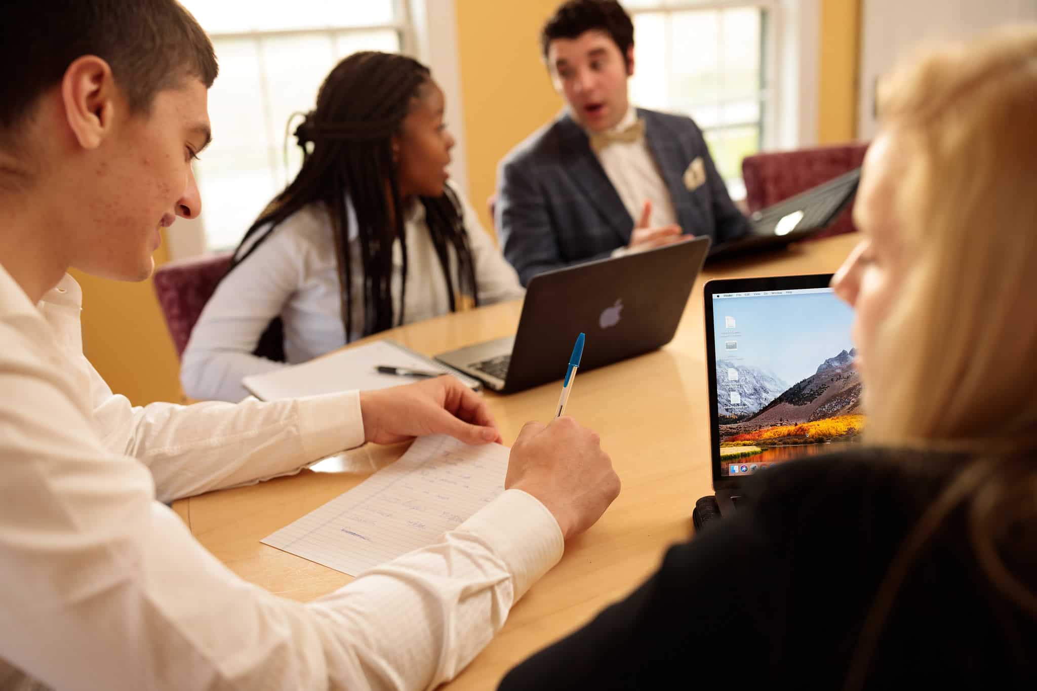 A group of students sitting around a conference table.