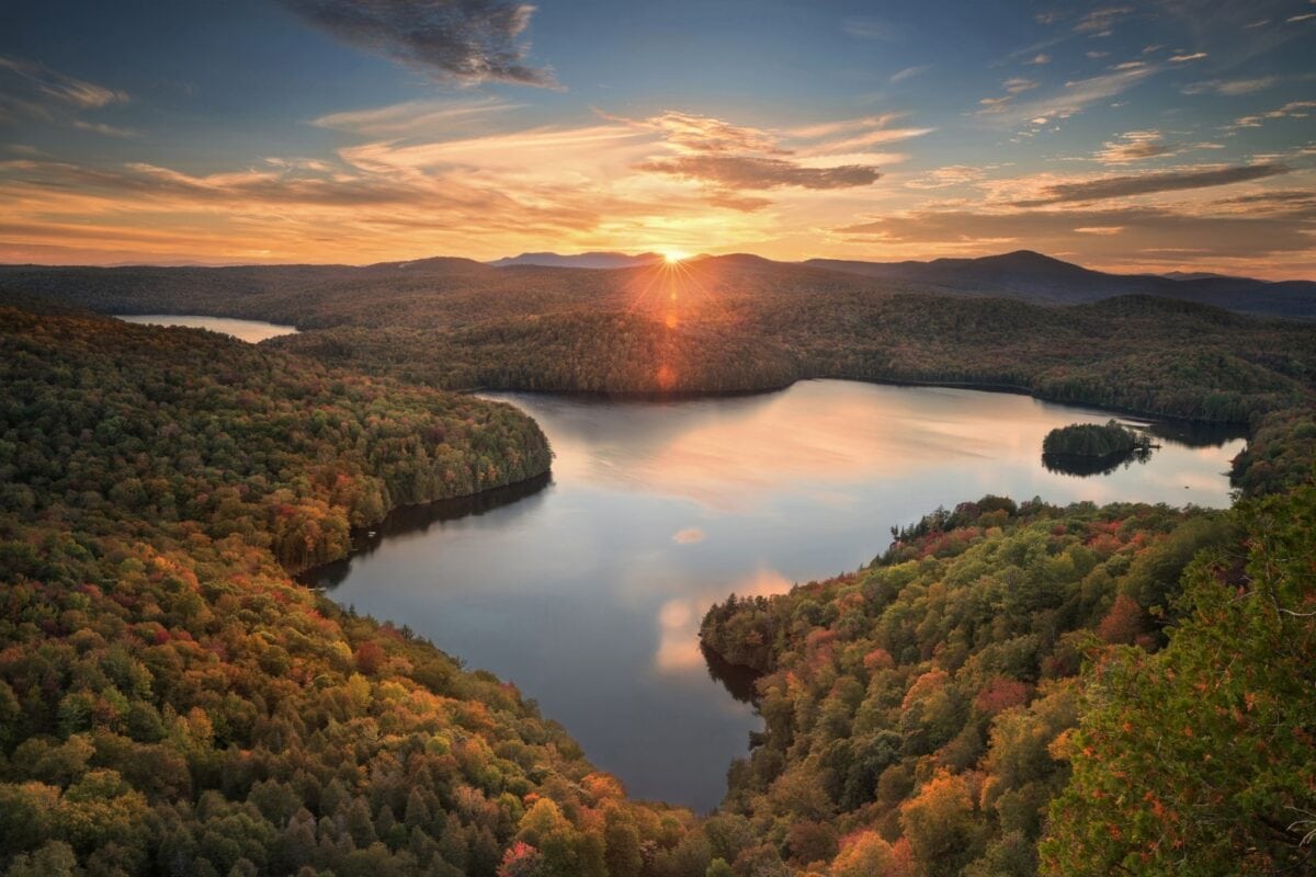 The view of a pond from the top of a mountain at sunrise.