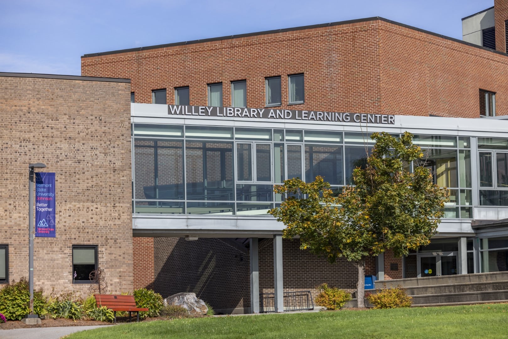 A brick building with a glass catwalk that says Willey Library and Learning Center.