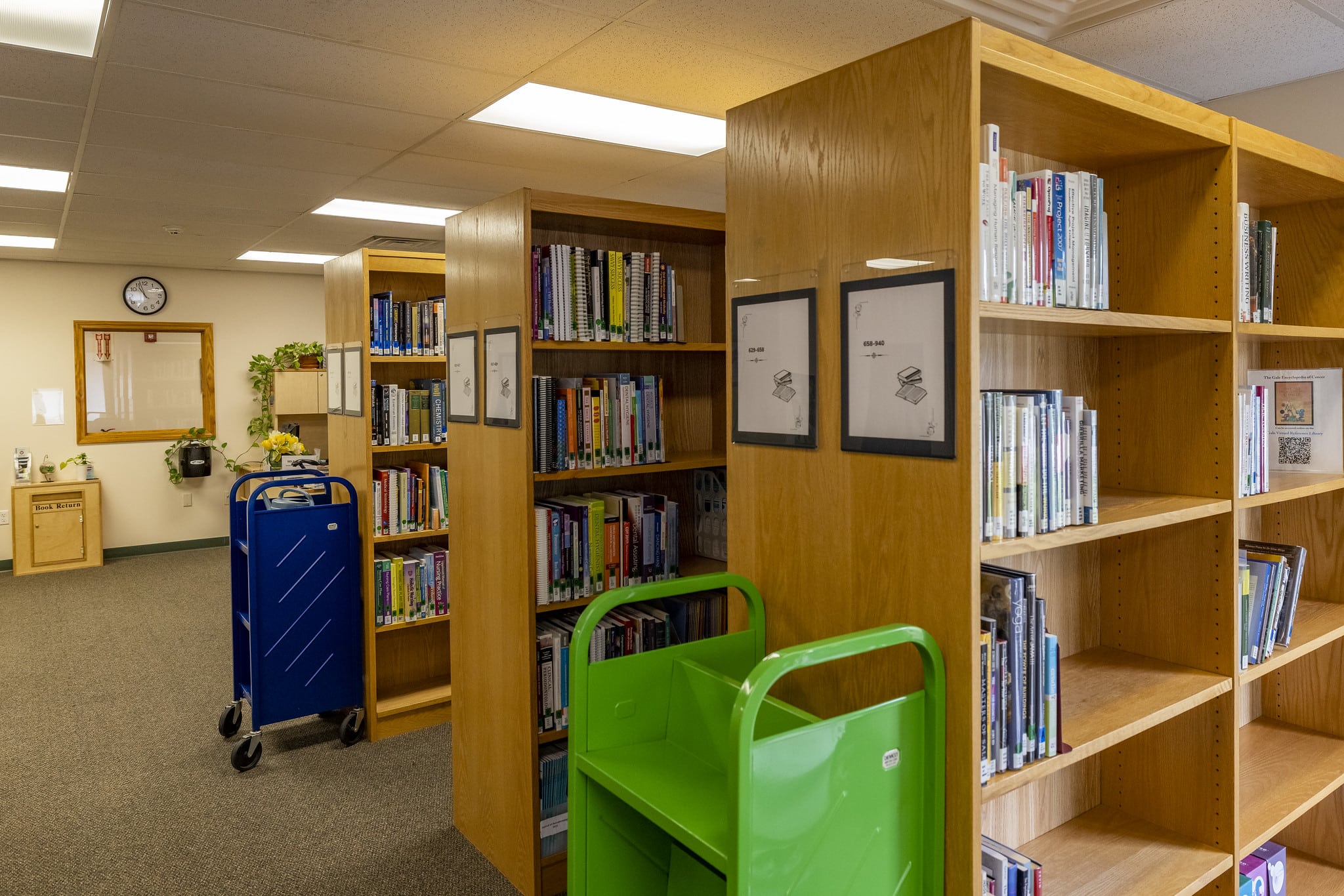 A line of bookshelves inside of the Williston Campus library.