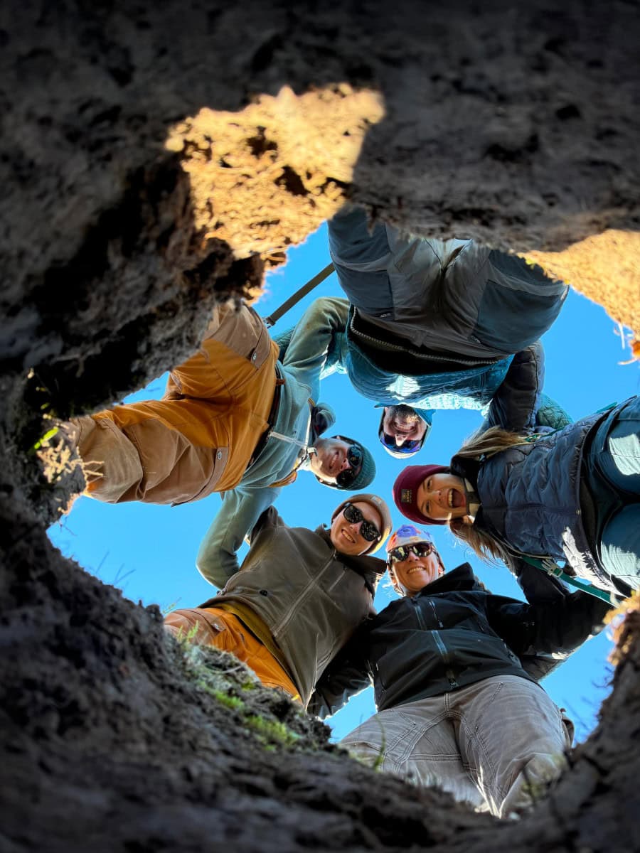 Five VTSU students look down through a hole.