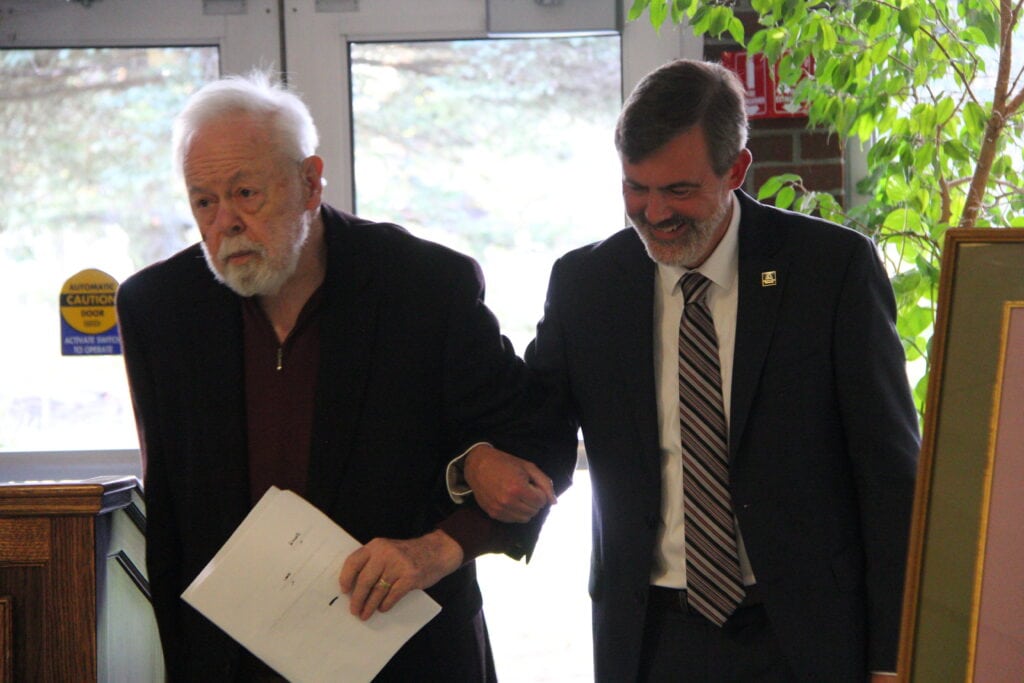 President Dave Bergh walking arm in arm with Ron Powers 