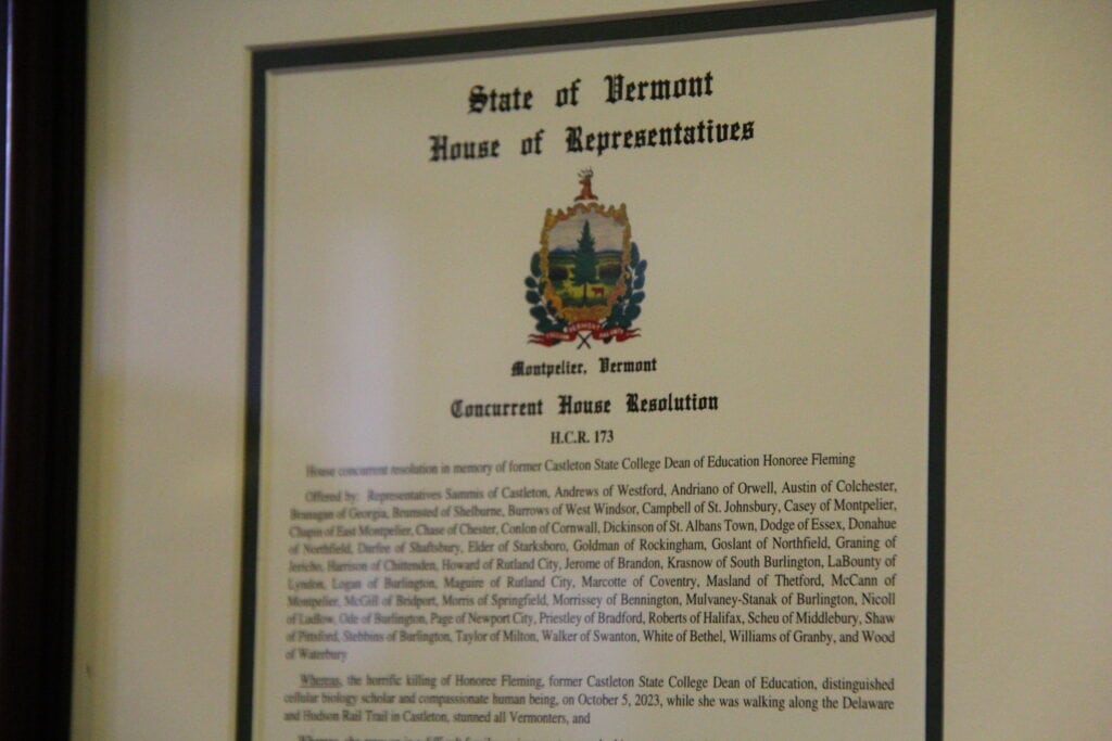 Plaque on the wall with a State of Vermont House of Representatives House Resolution in honor of Honoree Fleming. 