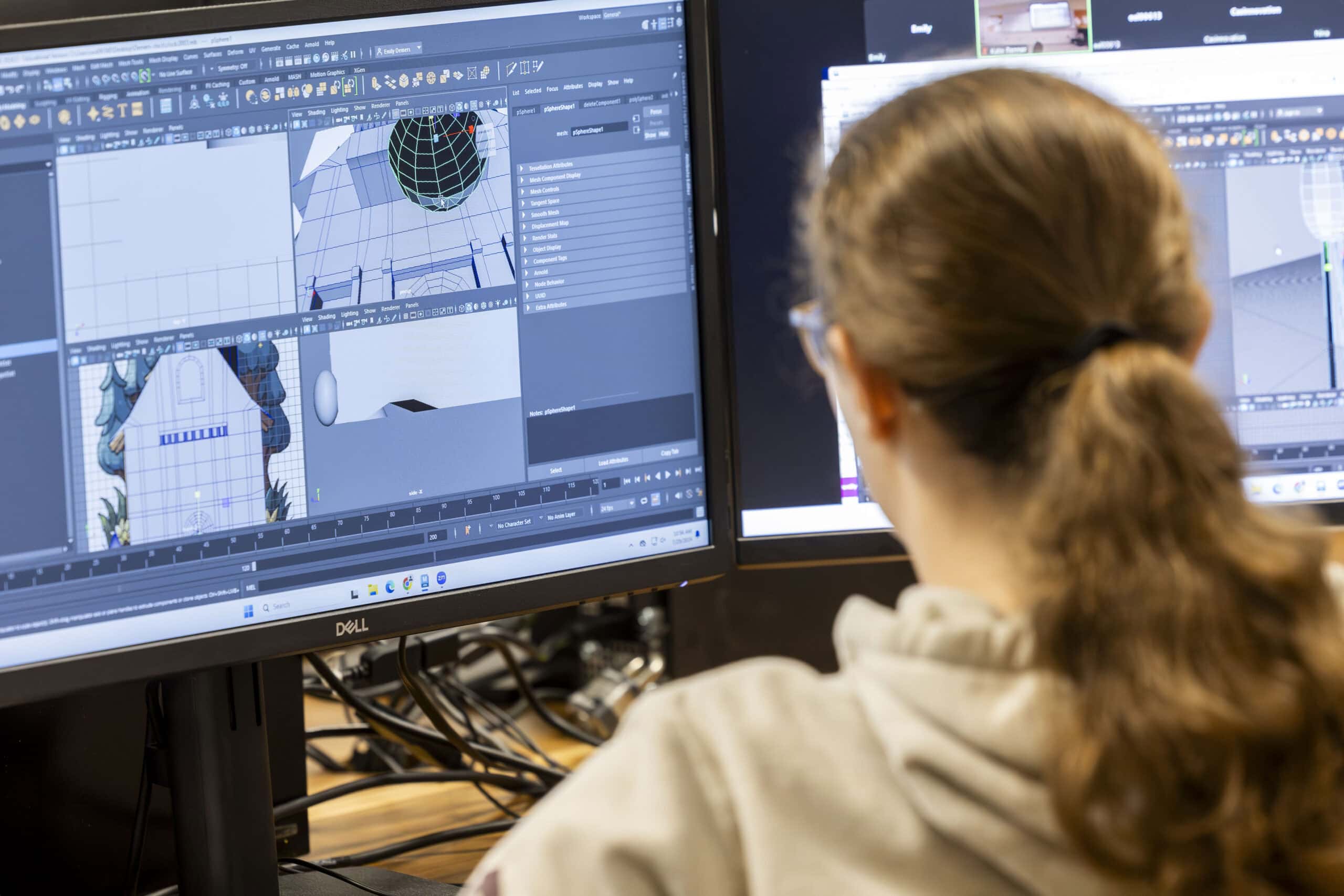 A student working at a computer using computer aided design software