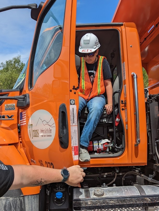 A middle school boy exiting a Vermont Department of Transportation truck