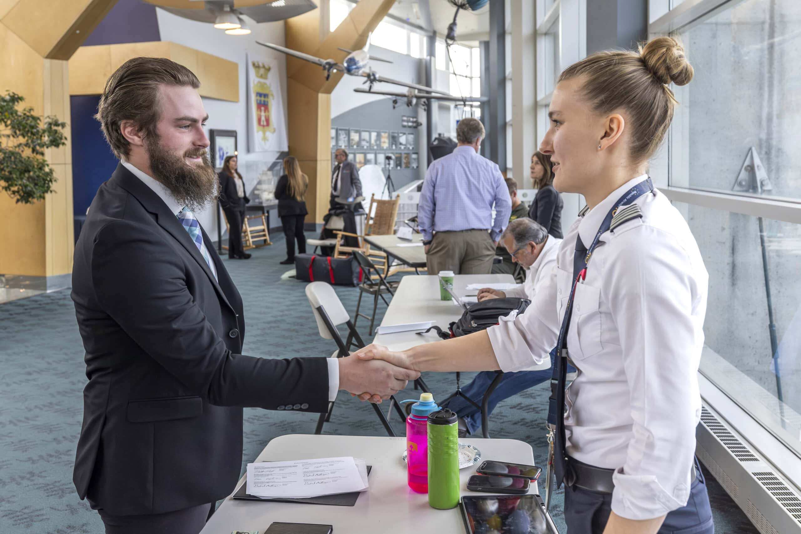 A pilot technology student at the Vermont State Williston campus shaking hands at a mock interview