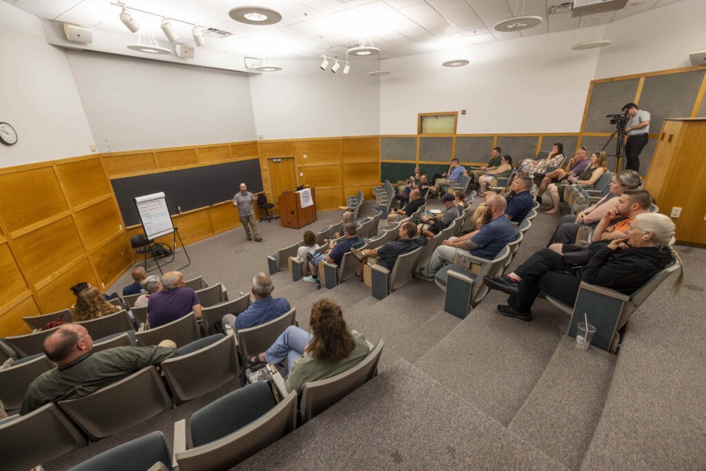 A group of first responders attending a conference sitting in a lecture hall at VTSU Castleton