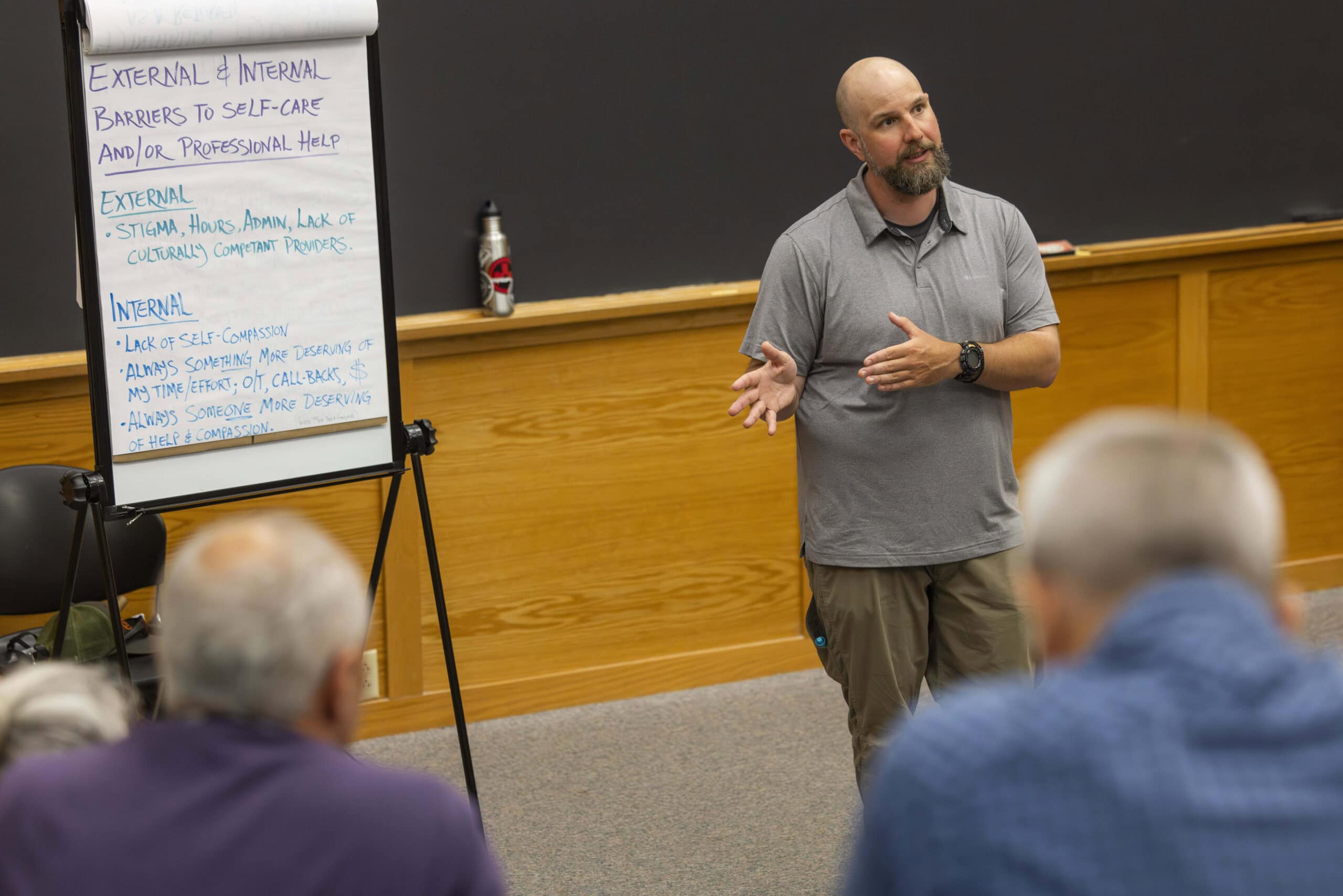 Mike Cancellieri, of Front Line Foundations, standing in a lecture hall and giving a presentation on self-care for first responders.
