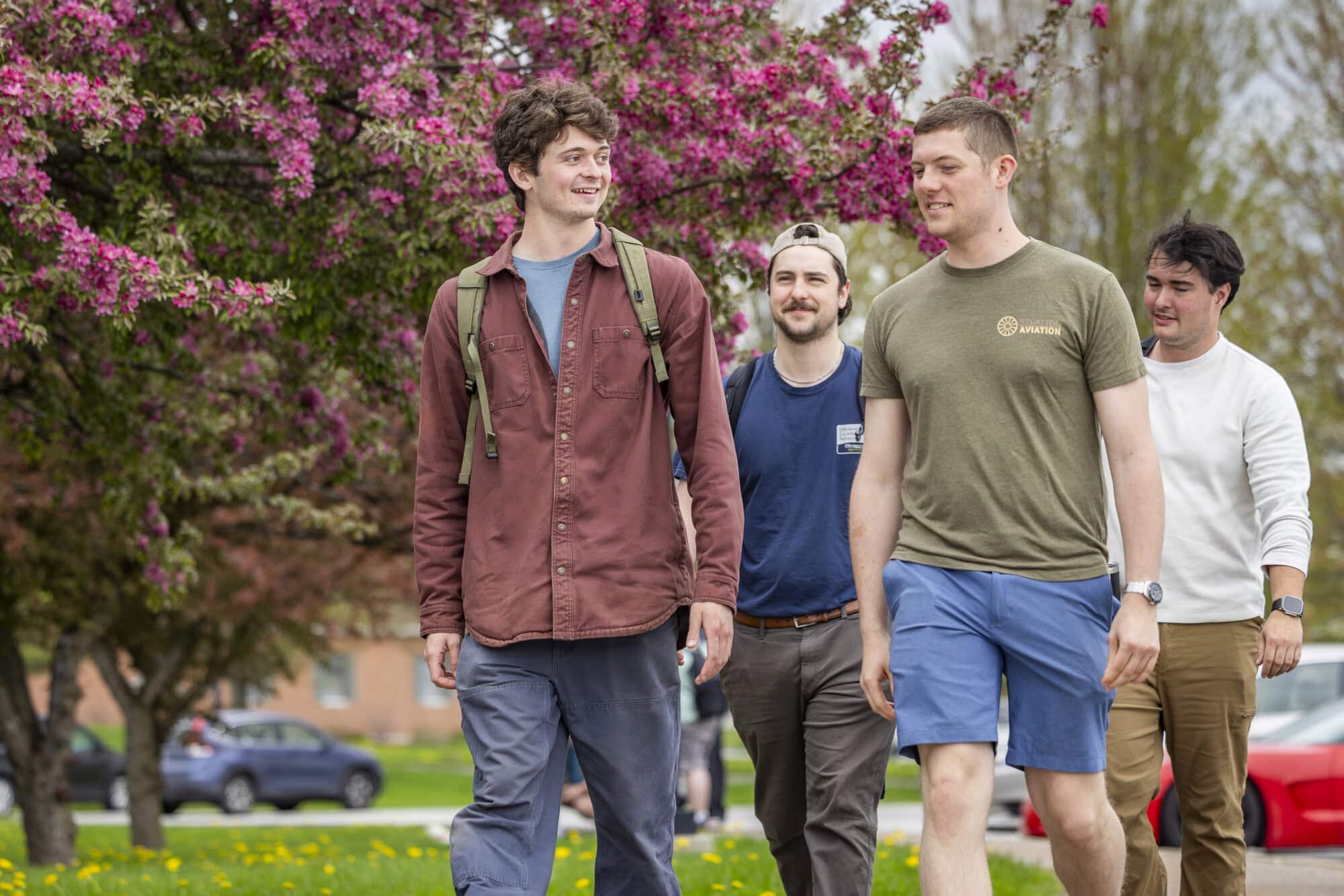 Students walking together through campus on a bright spring day