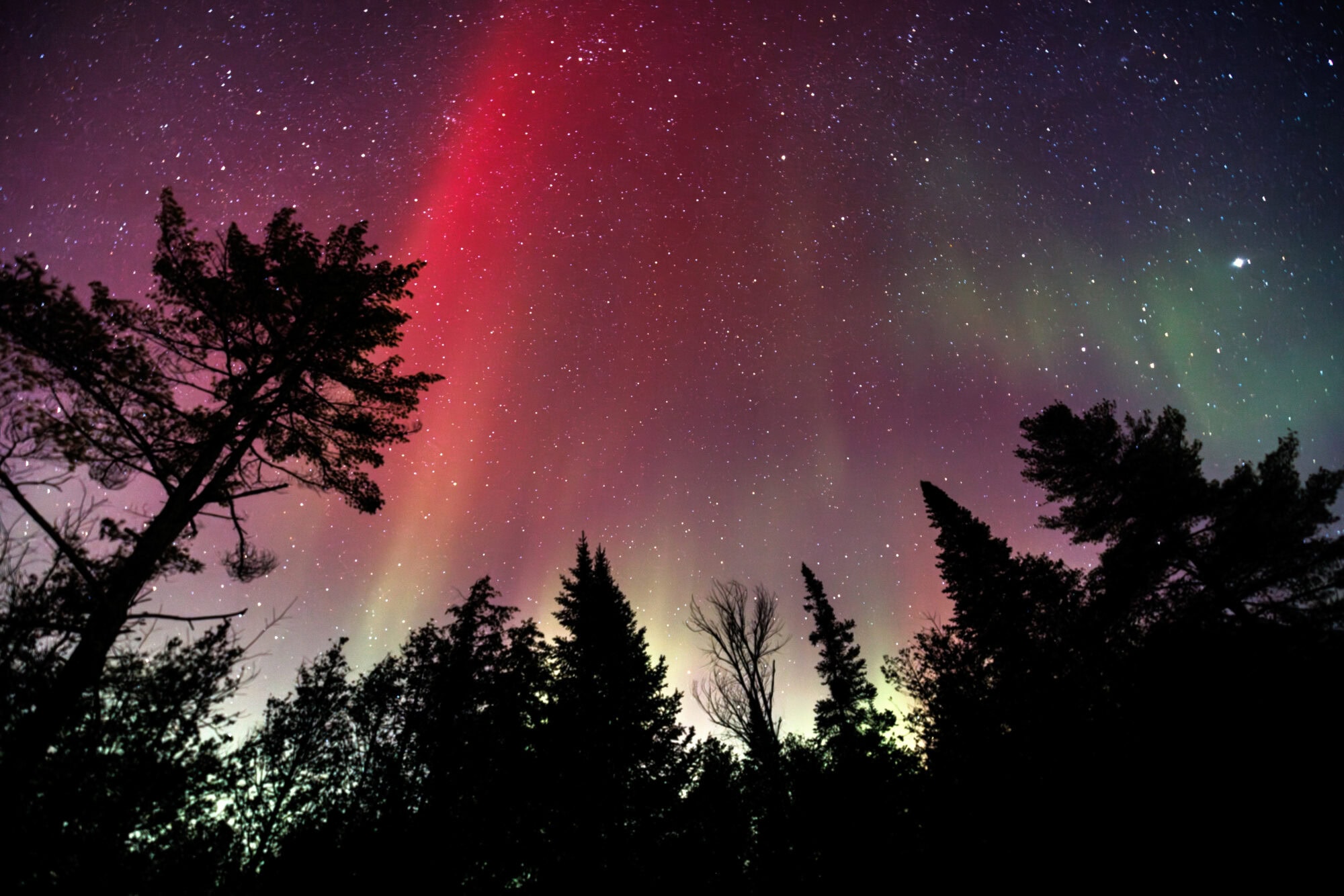 The Northern Lights fill the night sky with color in northern Vermont