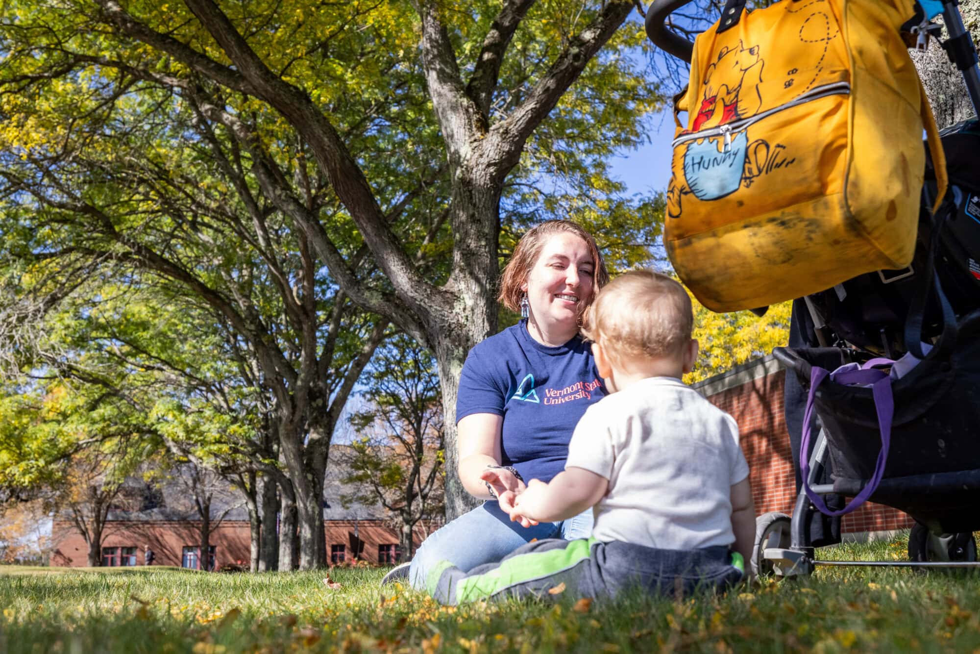 A student enjoys time outside with her 9-month-old baby between classes