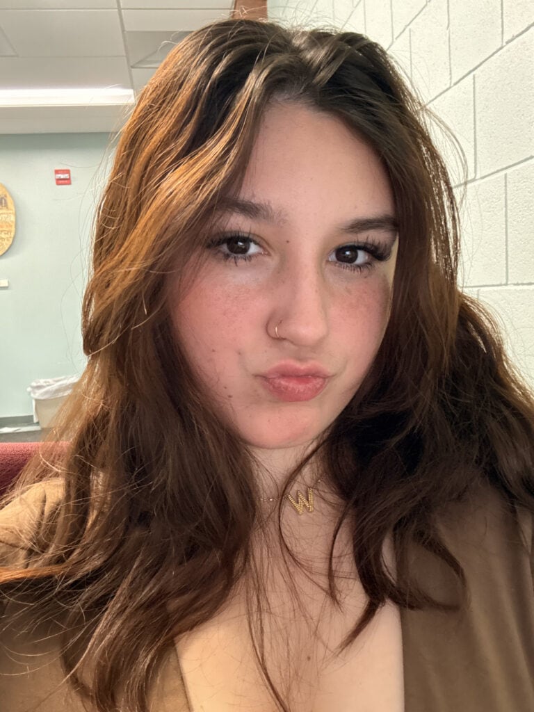 Carly Centeno sitting in a classroom and looking directly at the camera