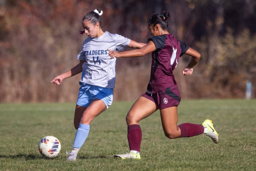 Two women playing soccer