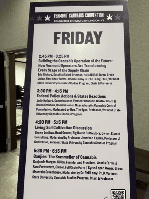 A printed schedule board for Friday sessions at the Vermont Cannabis Convention, held at the DoubleTree by Hilton in Burlington, VT, listing four panel discussions on cannabis operations, federal policy, living soil cultivation, and cannabis sommeliers.