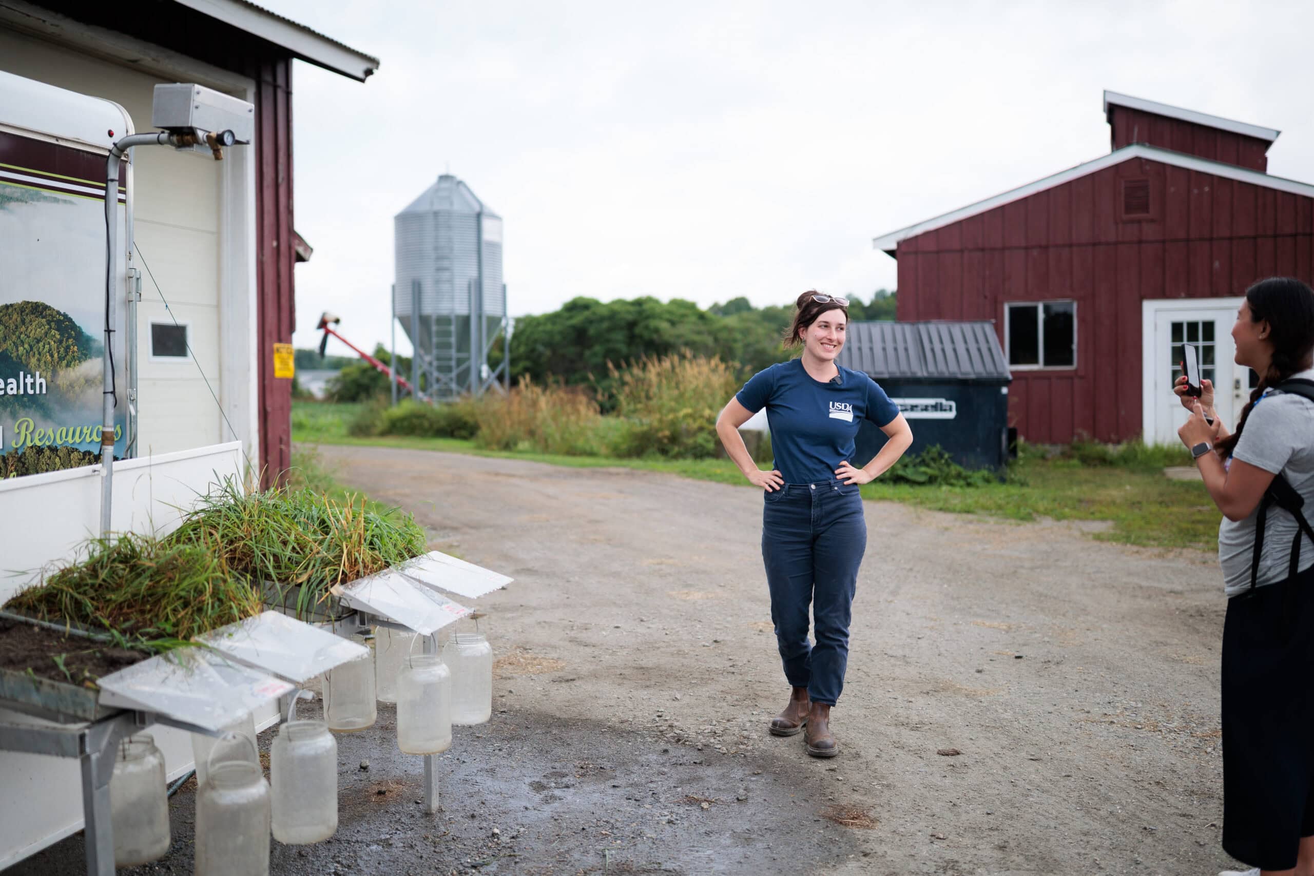 A woman wearing a USDA shirt standing by a grazing station at VTSU Randolph