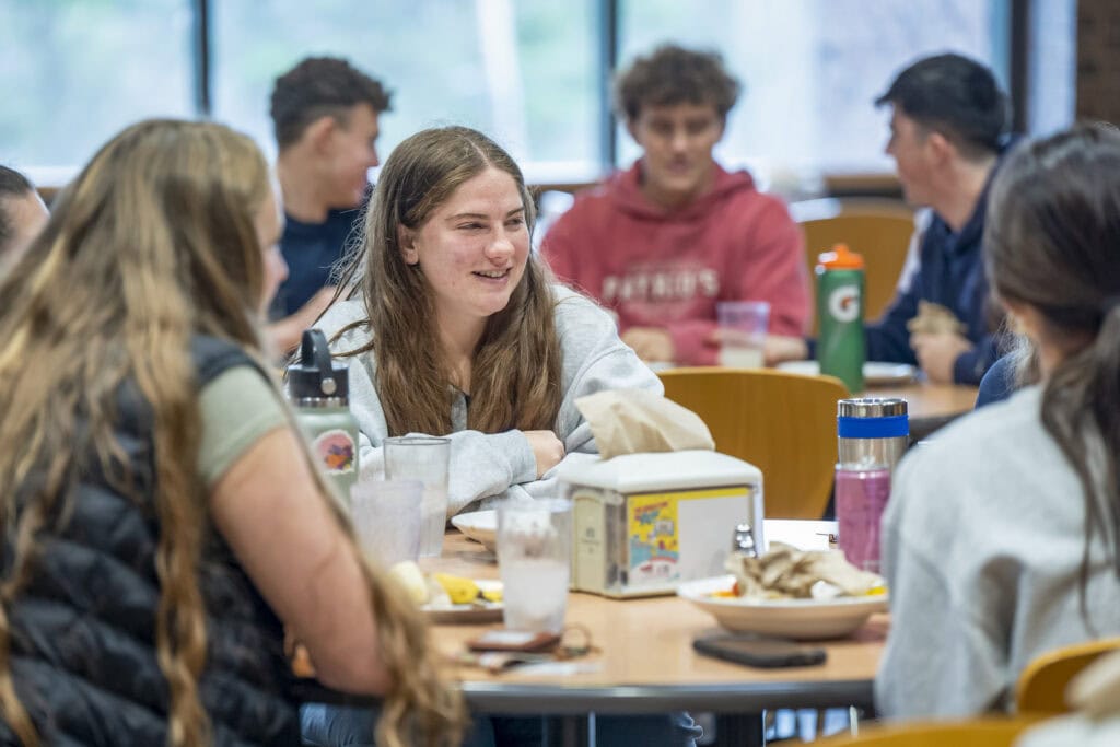 Students eat together inside the dining hall at Vermont State University Johnson 